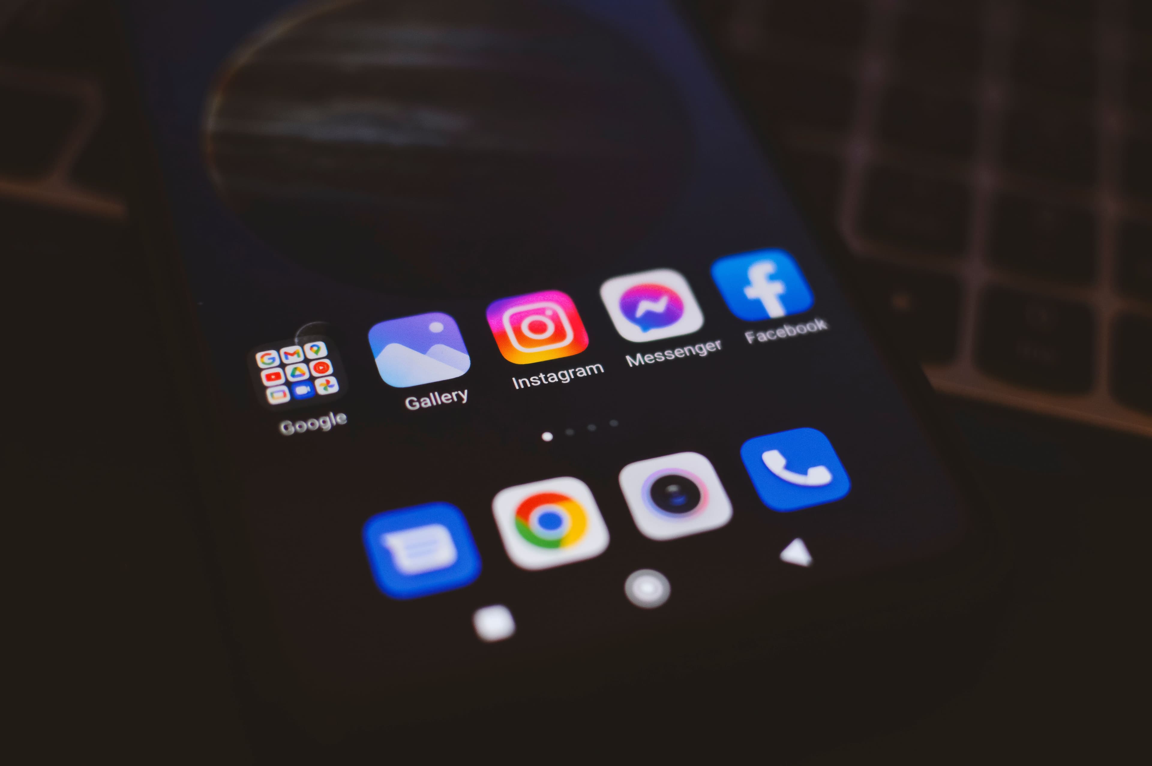 Image of phone displaying directory of social media apps.